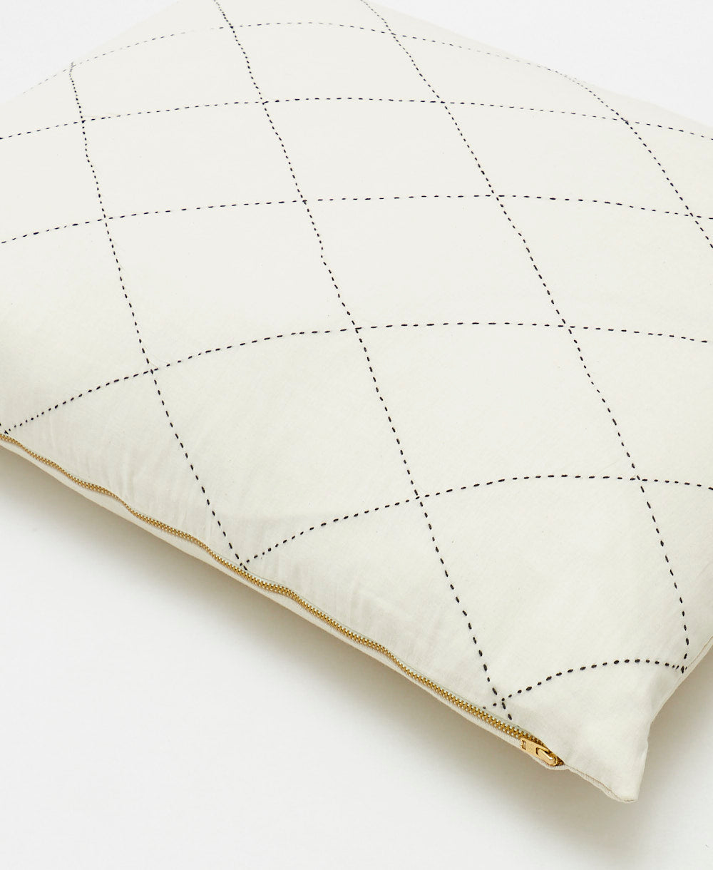 natural white pillow sham for a standard sized pillow with gold zipper closure & black embroidery details