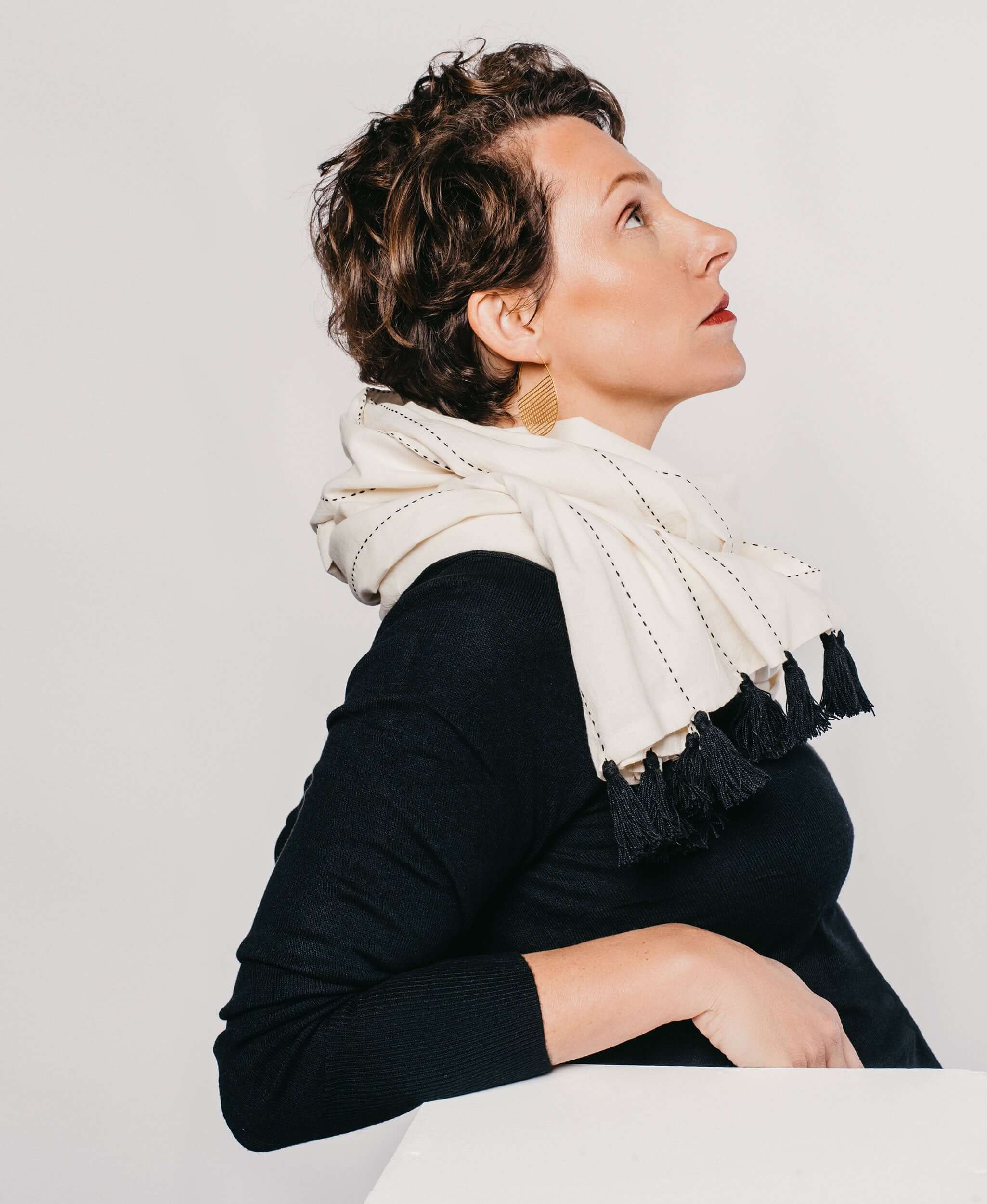 woman wearing didi long scarf featuring black tassels and black embroidery