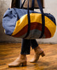 modern barrel shaped duffel bag with abstract rainbow design