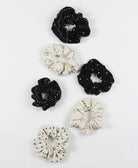 black and white embroidered scrunchies in different embroidery patterns made from 100% organic cotton