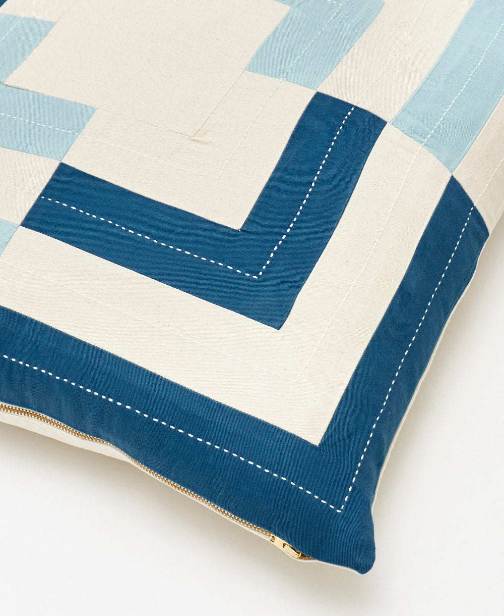 blue and white throw pillow with hand-embroidered stitching handmade in India by Anchal artisans