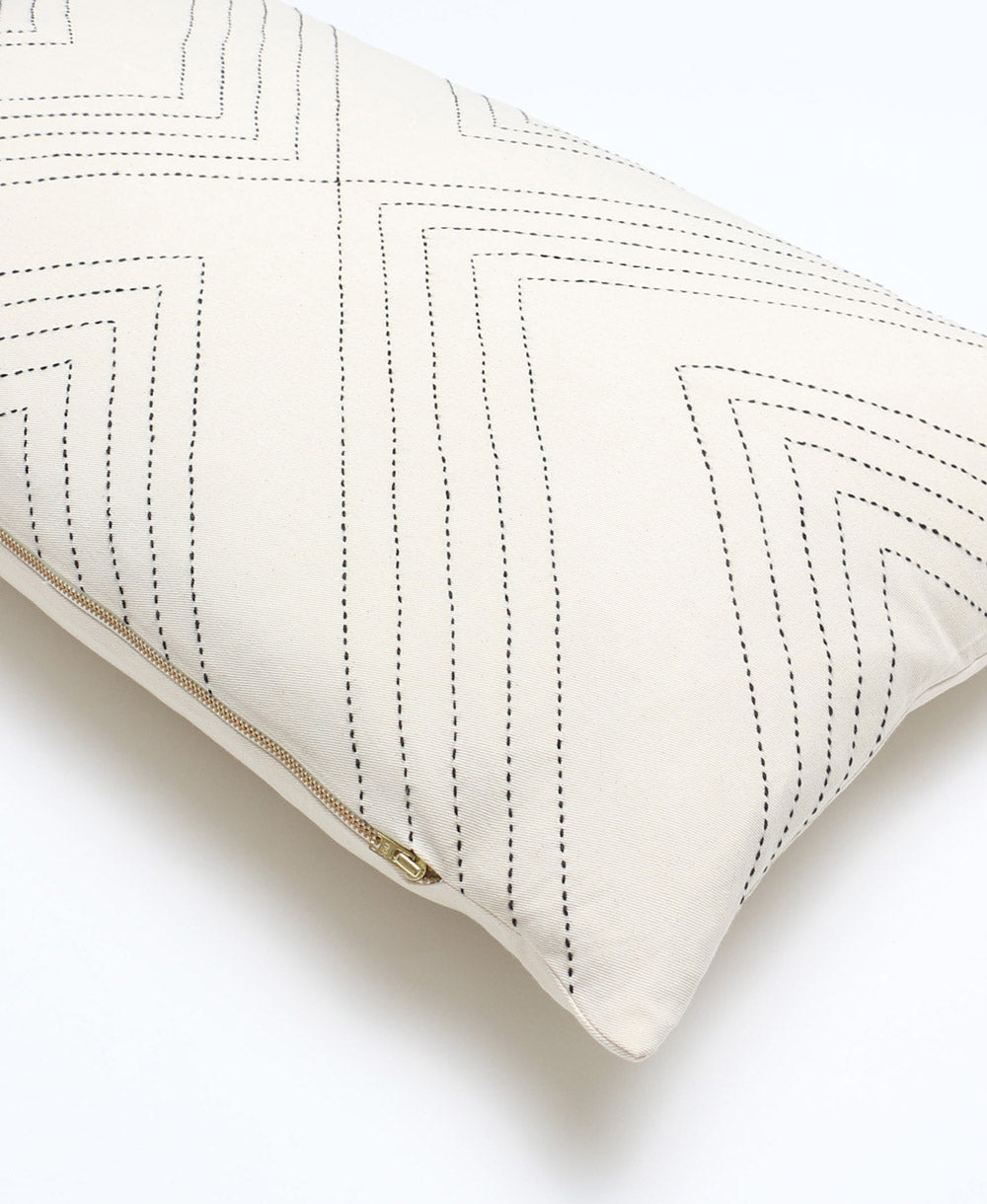 Fair Trade lumbar pillow with black geometric stitching with removable down feather insert and gold zipper