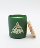 green jar candle with vinyl sticker logo on front and light wood maple lid in sandalwood scent