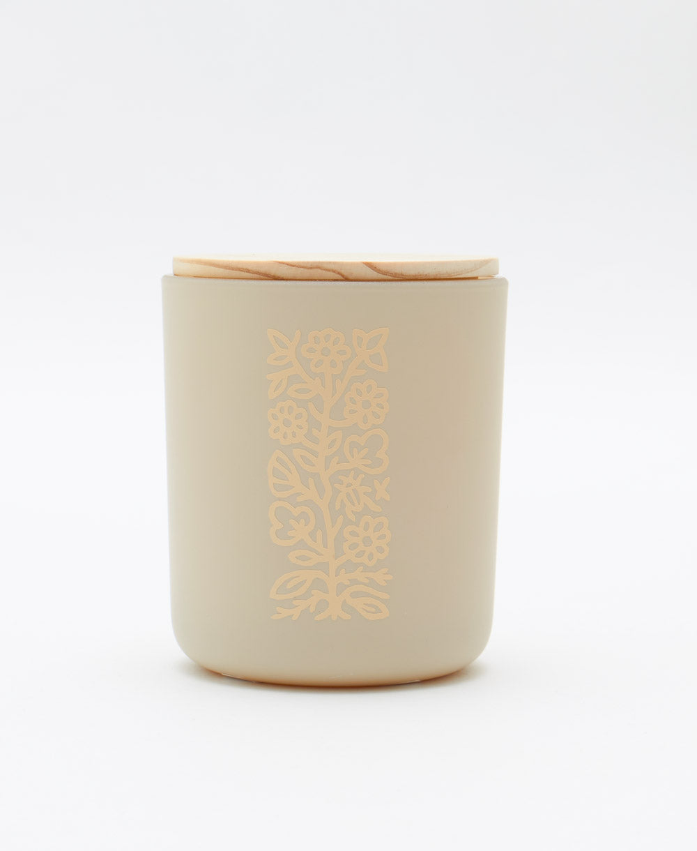 non-toxic candle in a blown glass jar in matte cream with a raw maple wooden lid in vanilla chai scent