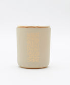 non-toxic candle in a blown glass jar in matte cream with a raw maple wooden lid in vanilla chai scent