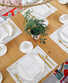 modern natural white cotton napkins and matching placemats on light wooden dining table