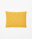 mustard yellow small pillow with white embroidery forming a geometric triangle pattern