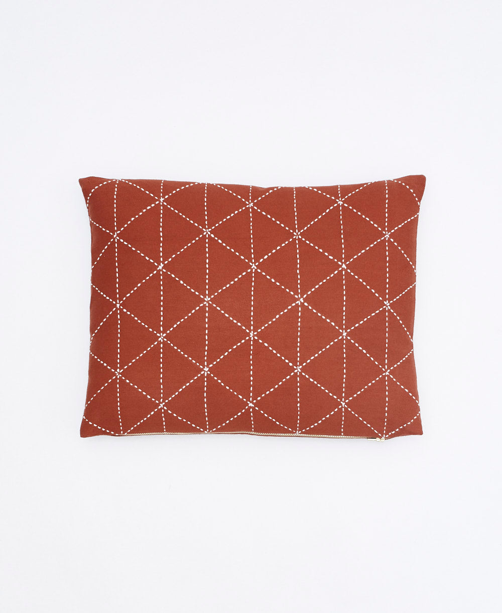 rust red small lumbar pillow with white kantha embroidery for the modern artisanal home