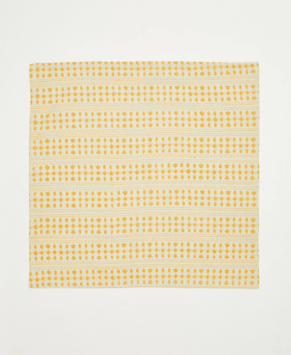 ethically handmade block print cotton napkin in mustard yellow and natural white striped floral