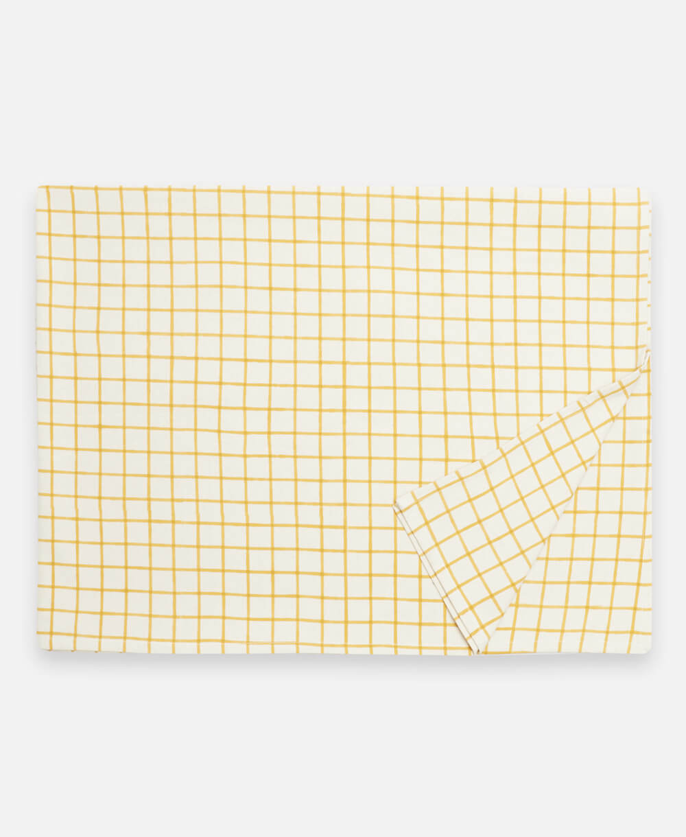 mustard yellow grid block print tablecloth in rectangular shape made from organic cotton