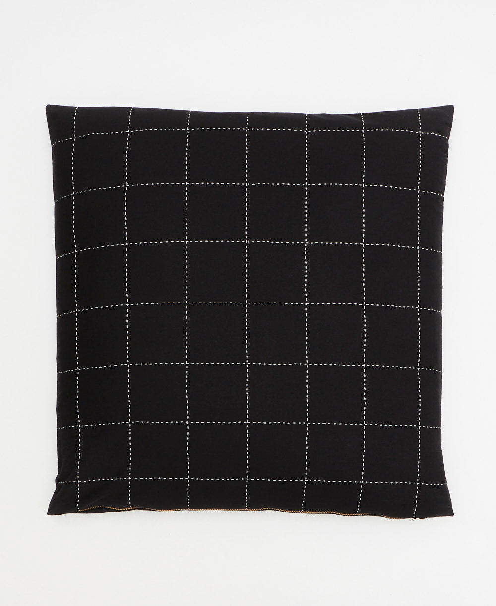 black throw pillow in embroidered grid design by Anchal