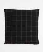 black throw pillow in embroidered grid design by Anchal