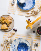 colorful yellow and blue table place setting with stuffed bunny