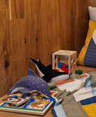 handmade stuffed animals featuring blue dolphin and black whale in play nook with matching blanket