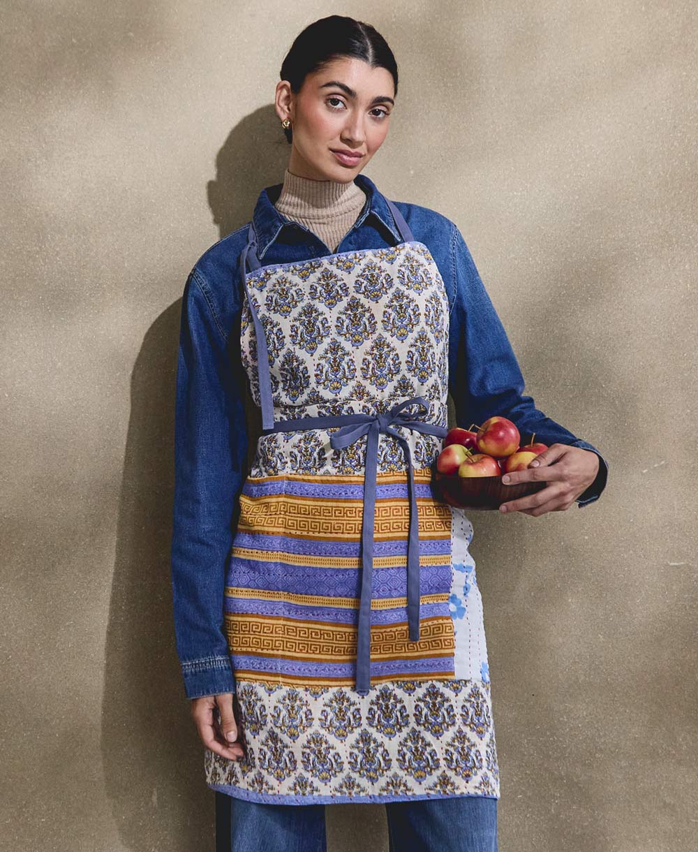 woman wearing colorful cotton full apron in blue & orange, adjustable with neck and waist ties