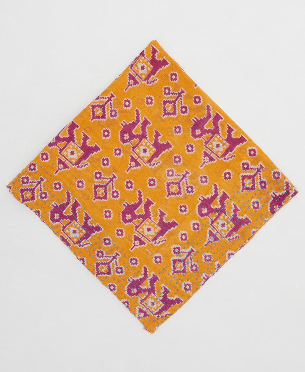 orange bandana with magenta elephant print with sky blue embroidery along edges