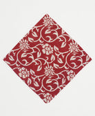 cherry red bandana with a white graphic floral print and hand-embroidered edges