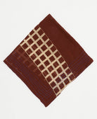 brown cotton bandana with tan grid accent pattern with blue embroidery along edges