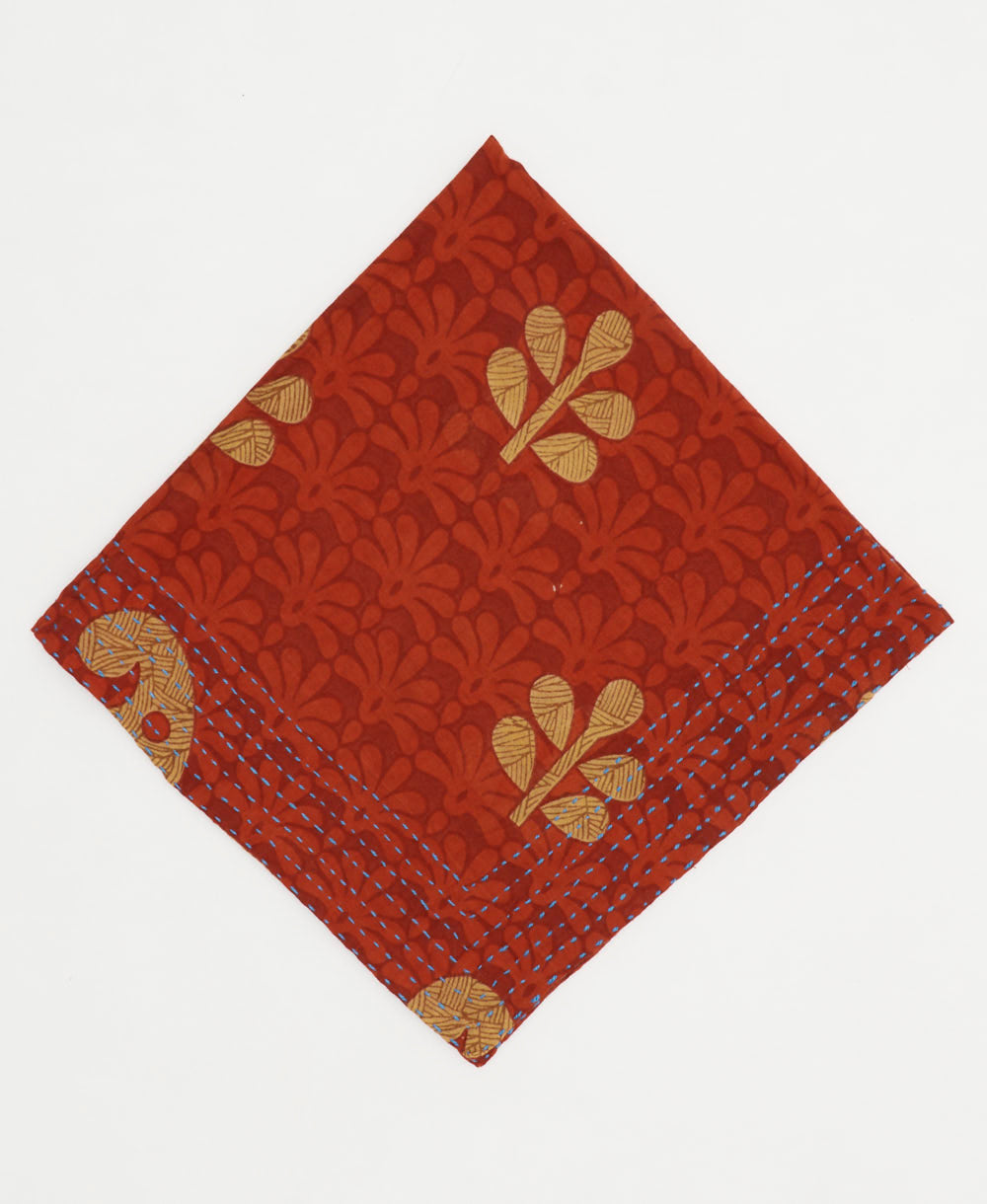 rust red cotton bandana in floral print with tan leaf accents