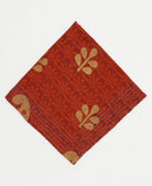 rust red cotton bandana in floral print with tan leaf accents