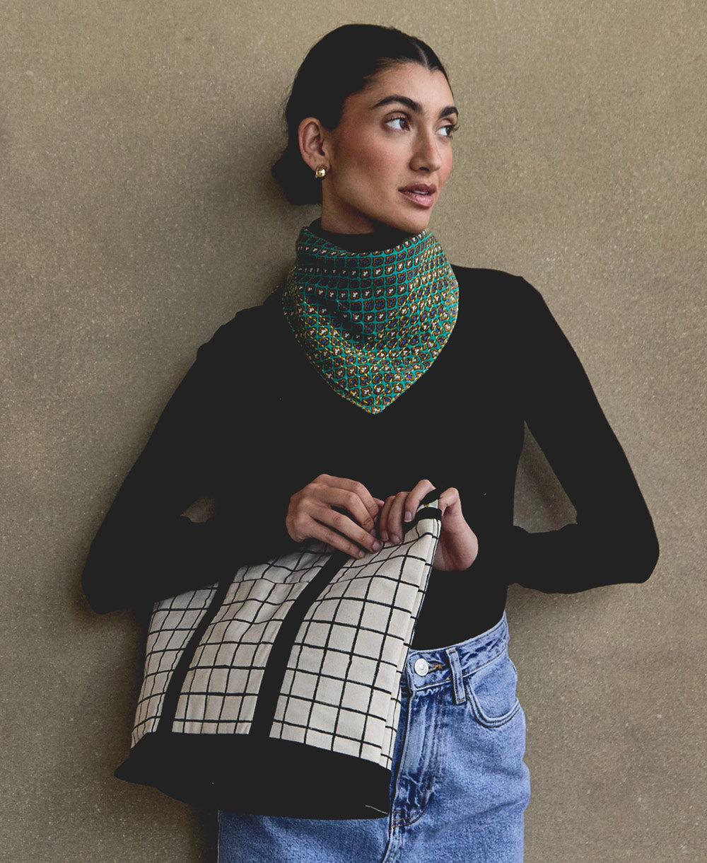 woman wearing black turtleneck with bold green diamond print cotton bandana scarf with yellow embroidery