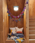 wooden reading nook with purple scallop banner and purple pennant banner hanging