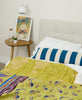 lime green kantha quilt blanket with blue horizonal stripe lumbar pillow on all white bed