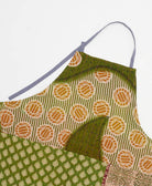 sustainable adjustable apron in olive & pumpkin circle print made from one-of-a-kind saris with pink embroidery