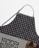 sustainable adjustable apron in black diamond print made from one-of-a-kind saris with red embroidery