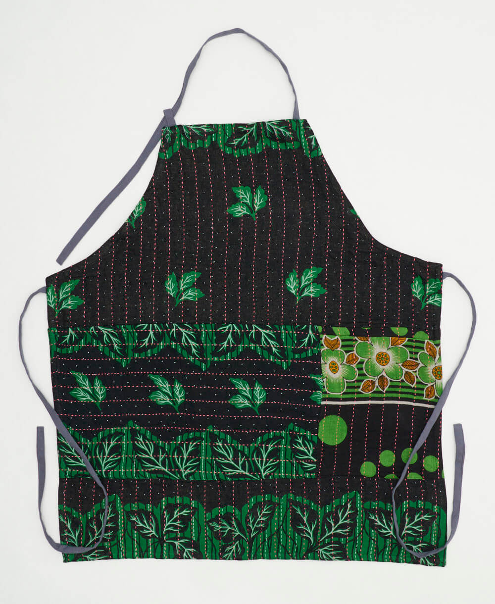 dark navy cotton apron with emerald green leaf print and slate blue adjustable ties