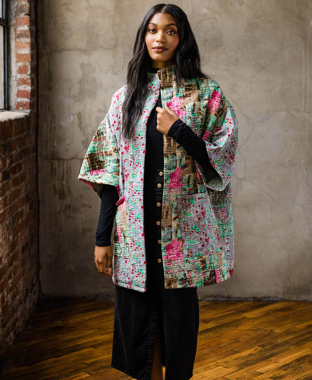 woman wearing one-of-a-kind quilted jacket handcrafted from upcycled vintage cotton saris with 2 front pockets