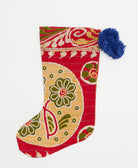 cherry red holiday stocking in traditional print with blue pom poms