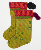 eco-friendly holiday stockings made from upcycled cotton saris in India in olive green fabric and hand-embroidered stitching