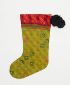 unique holiday stocking handmade from vintage cotton saris in India featuring an olive green subtle stripe print with black pom poms