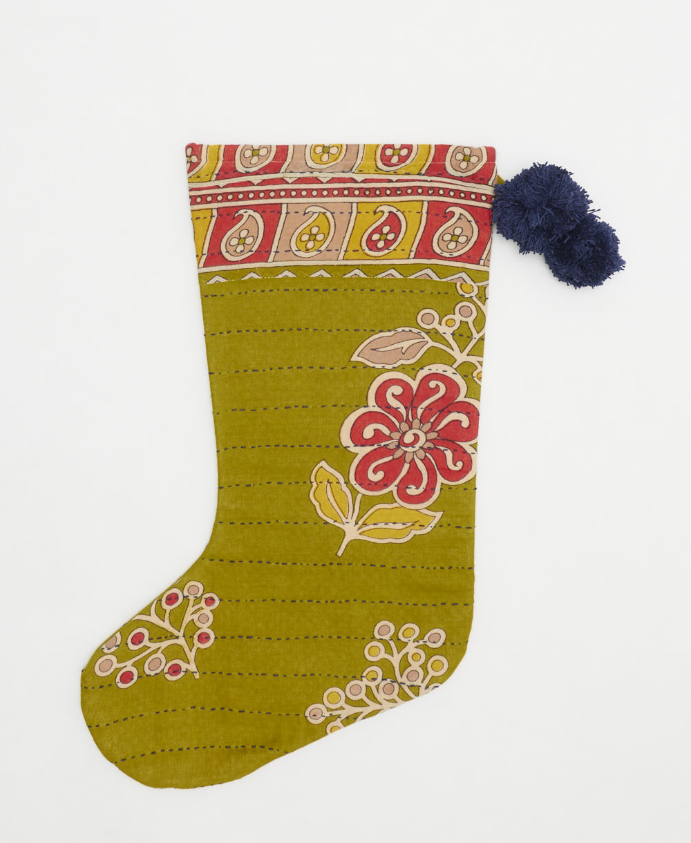 unique holiday stocking handmade from vintage cotton saris in India featuring an olive green and pink floral print with navy blue pom poms