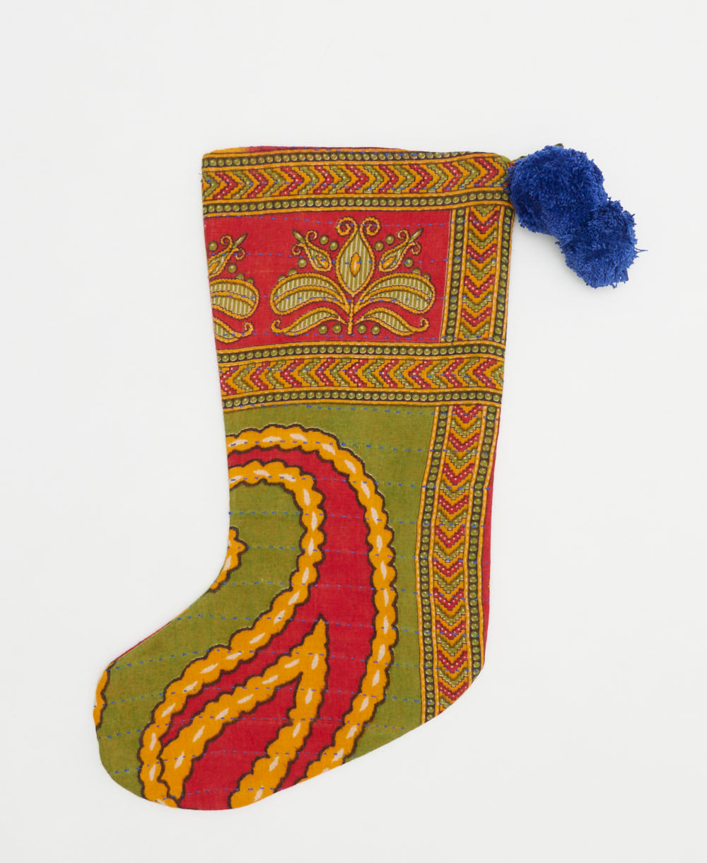 olive green holiday stocking in oversized paisley print with royal blue pom poms