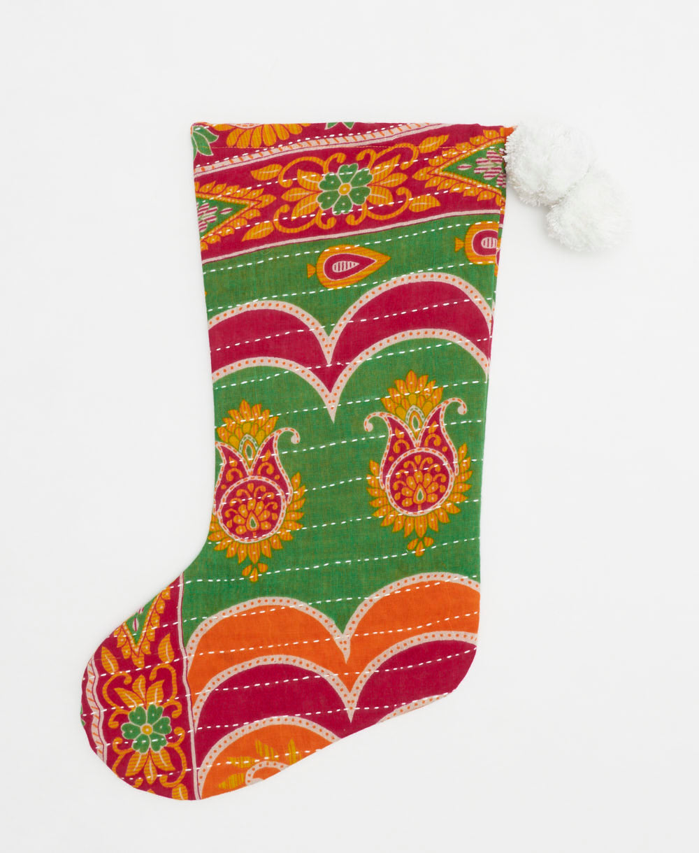 green & magenta holiday stocking in medallion print with white pom poms