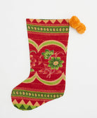 crimson red holiday stocking in lime green flower print with orange pom poms