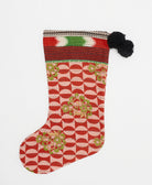 red & white holiday stocking in retro geometric print with black pom poms