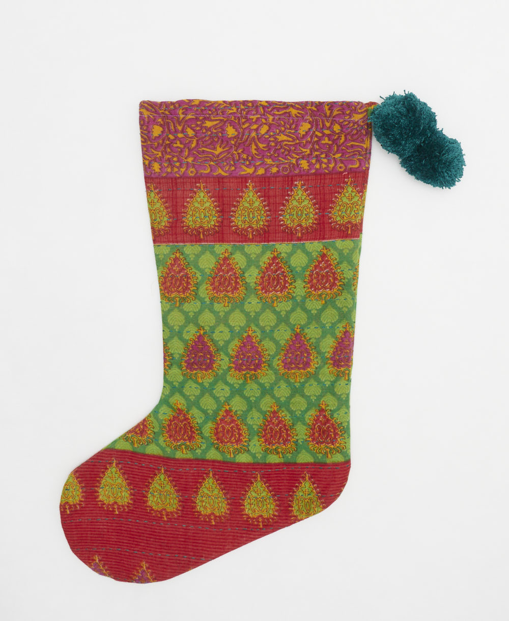 cherry red & bright green holiday stocking in abstract leaf print with teal pom poms