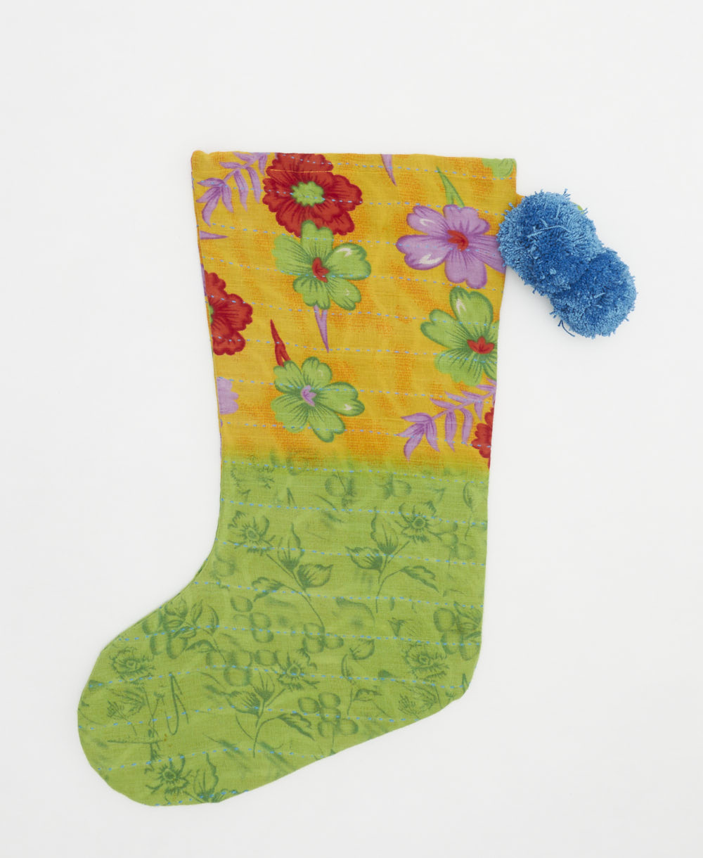 lime green holiday stocking in tropical floral print with blue pom poms