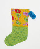 lime green holiday stocking in tropical floral print with blue pom poms