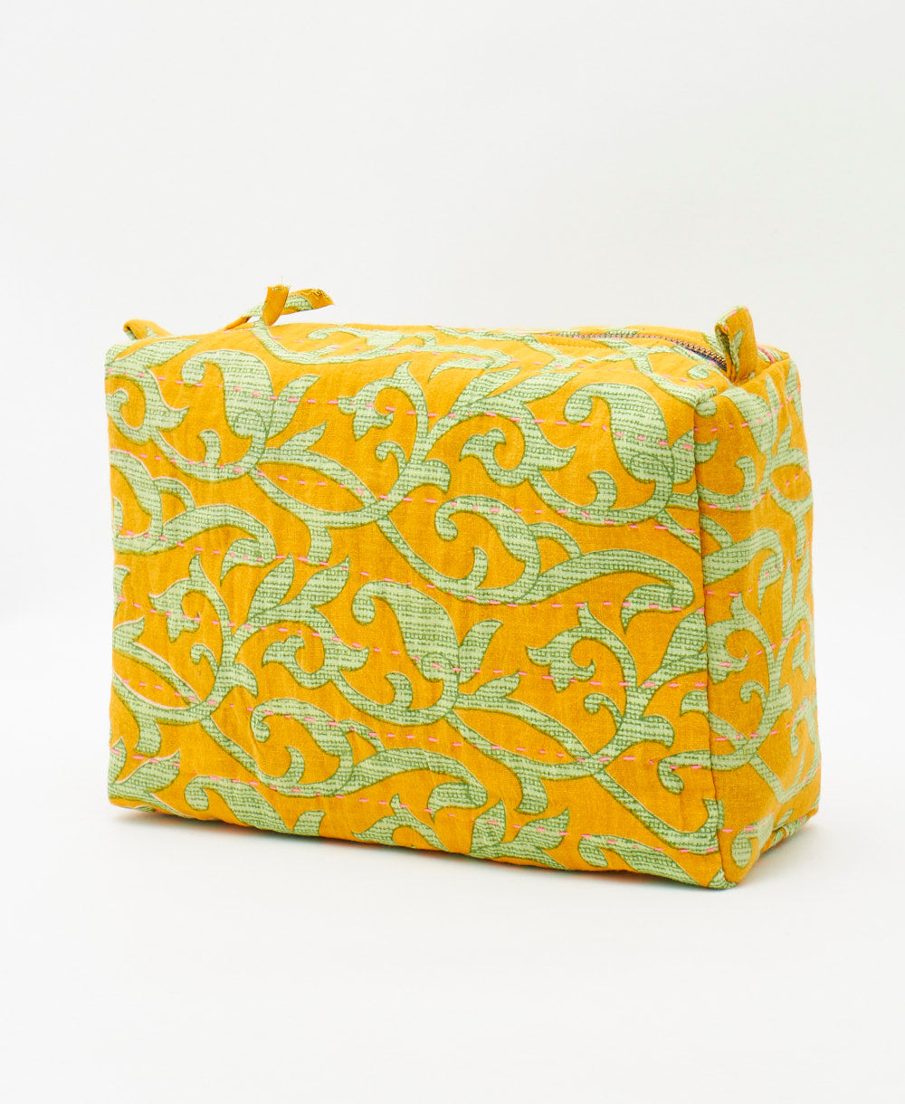 one-of-a-kind large cosmetic bag hand made by artisans in india using amber yellow fabrics 