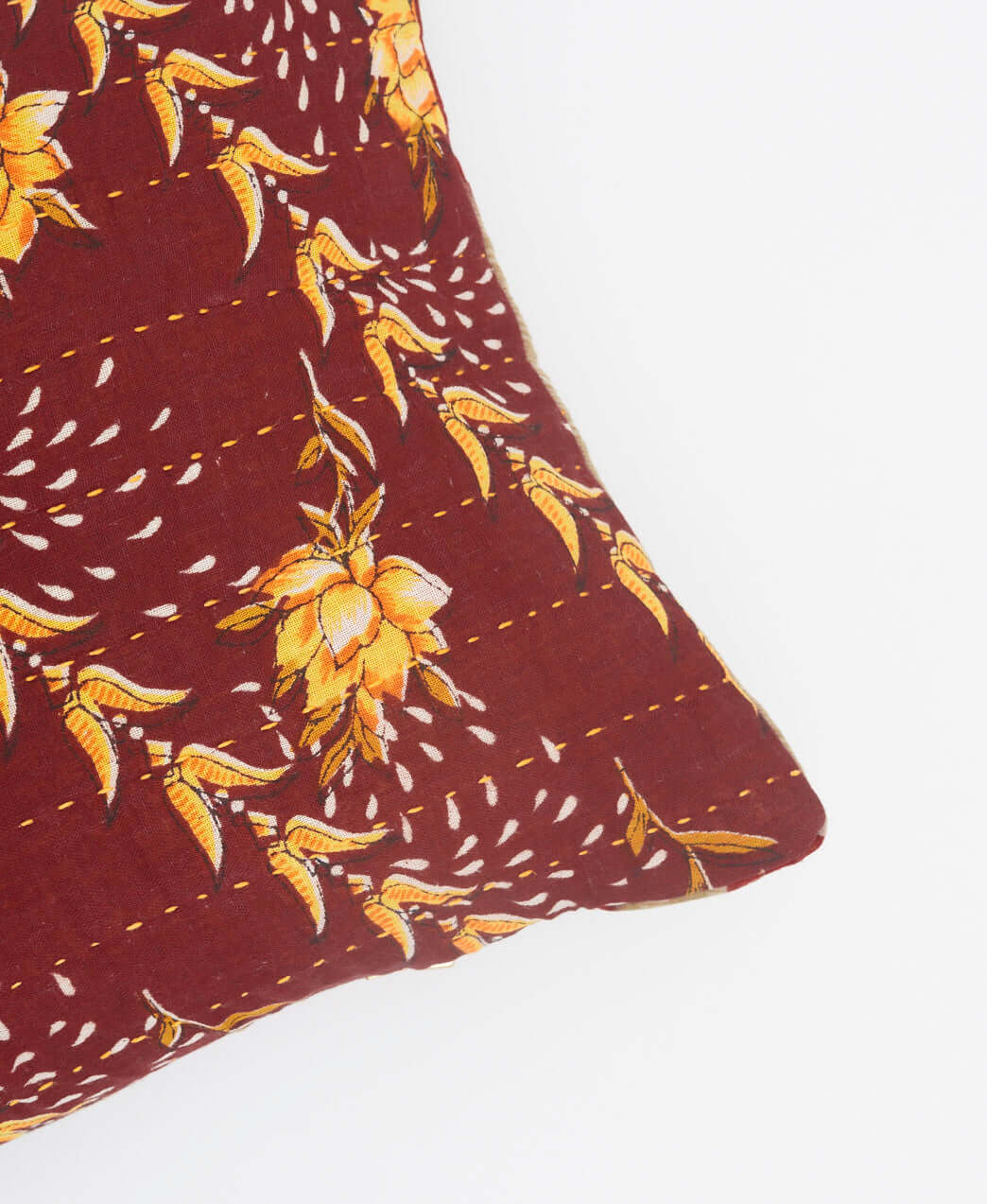 yellow kantha embroidery on maroon lumbar pillow with yellow flowers