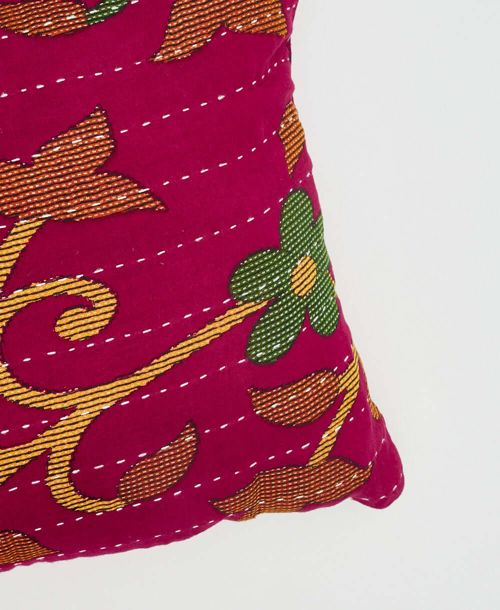 embroidered lumbar pillow in hot pink with white hand-stitching by women artisans in India