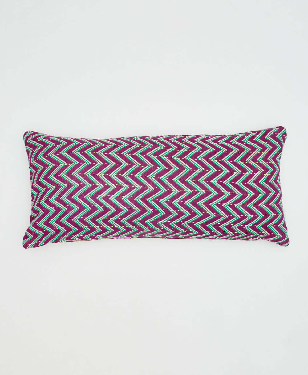 magenta purple lumbar pillow with teal & white zig zag chevron pattern on back of pillow