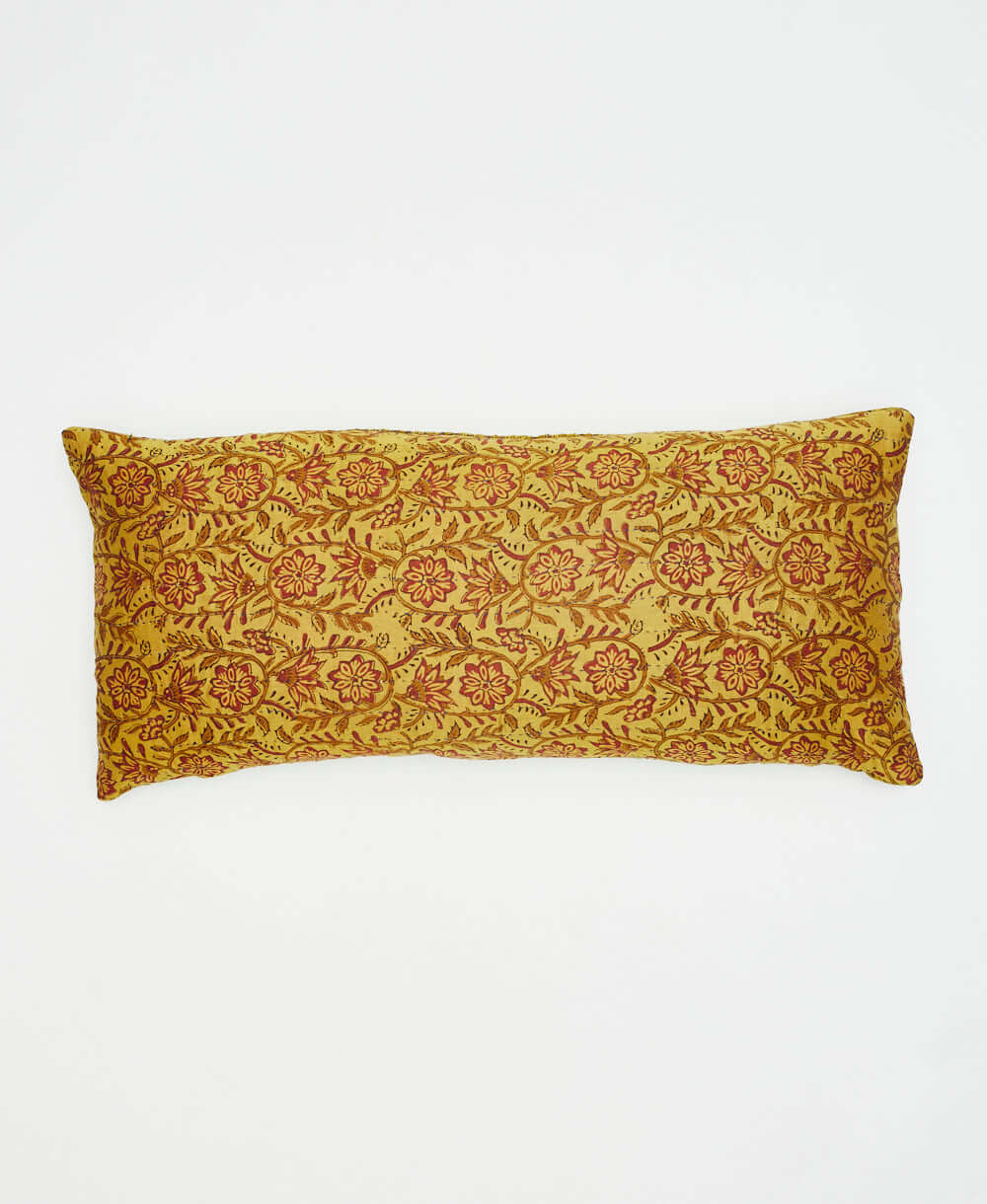 beautiful mustard yellow lumbar pillow with red floral design on the front