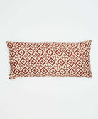 light tan lumbar with maroon southwestern diamond print on back of reversible pillow