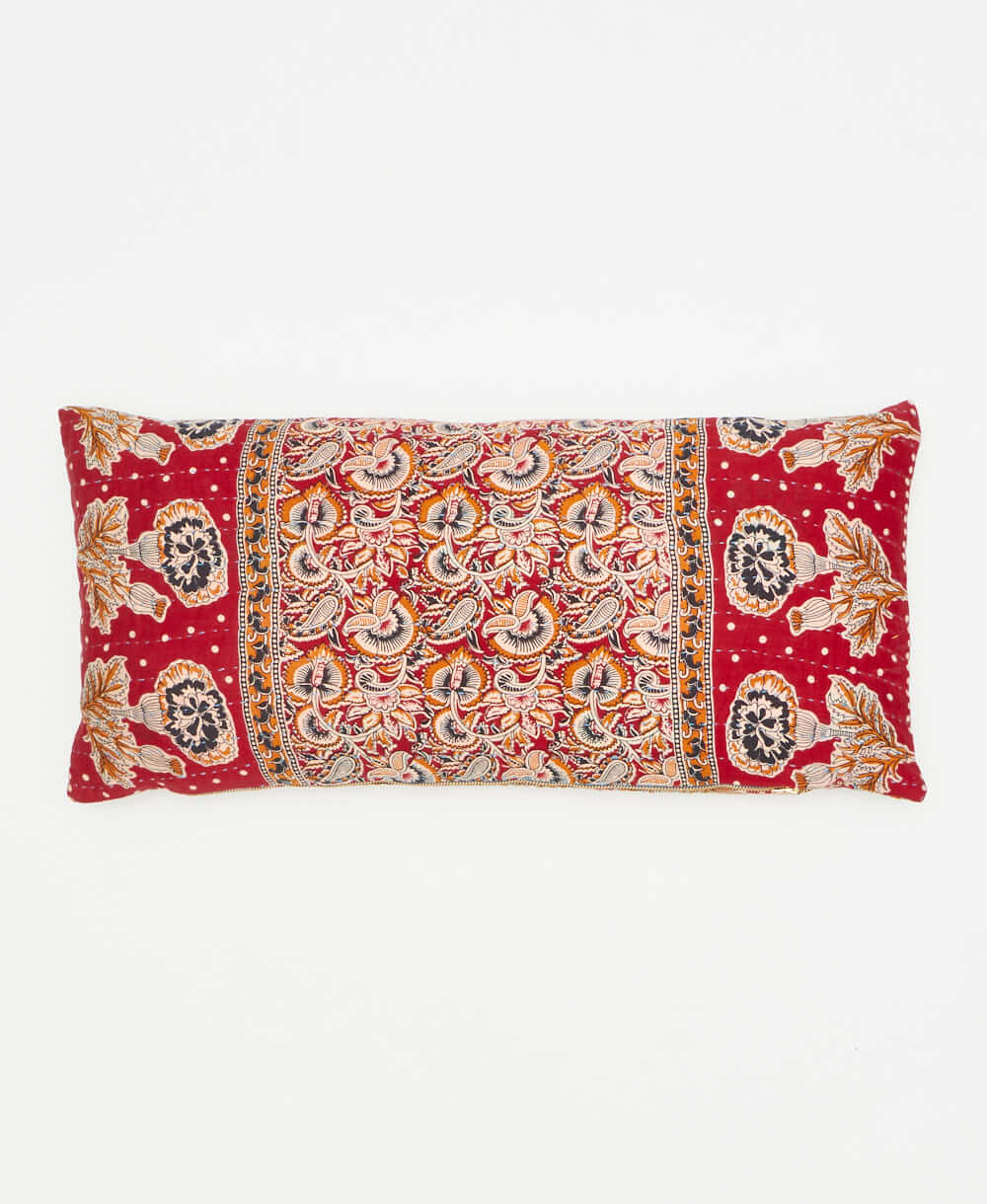 lumbar pillow featuring a gold red paisley print and hand stitching 