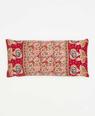 lumbar pillow featuring a gold red paisley print and hand stitching 